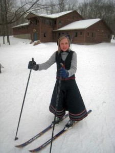 Emma Ellefson upon completing the Lotvola Cup with a pair of wooden skis and traditional Norwegian attire.