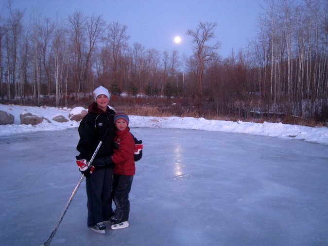 Jon and Jens checking out the fresh ice on the ice skating rink as the full moon rises in the east.