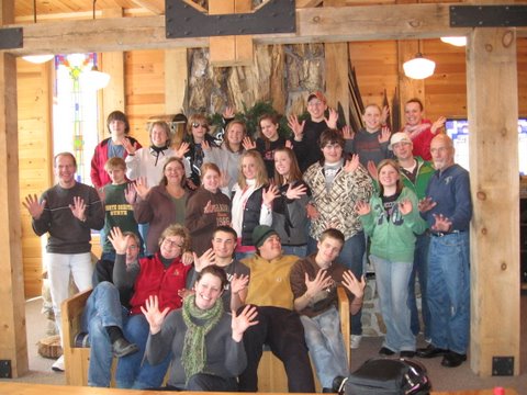 Kids from Kamp Kace (Kids Against Cancer Everywhere) in front of the fireplace after a weekend of winter fun at Maplelag.