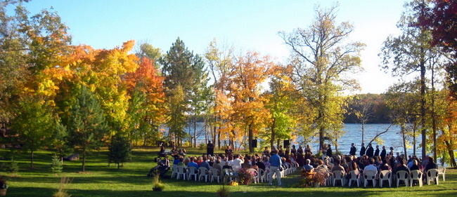 Fall wedding ceremony on the shores of Little Sugarbush at Maplelag.