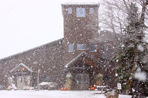 Heavy snow falling in front of the lodge around noon on Friday. 