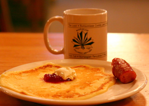 Norwegian Pancakes served every Saturday morning during the winter featuring imported lingonberries, sour cream, pure maple syrup and farm sausage.