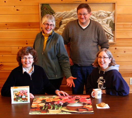 Jim and Nancy Barbour, Nancy Carpenter and Cheryl Rempel doing Morris proud upon completion of Seasonal Splendor jigzaw puzzle after a four day stay at Maplelag recently.