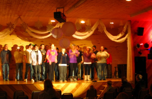 Kamp Kace group performing the red barn song for the Maplelag Saturday night variety show.