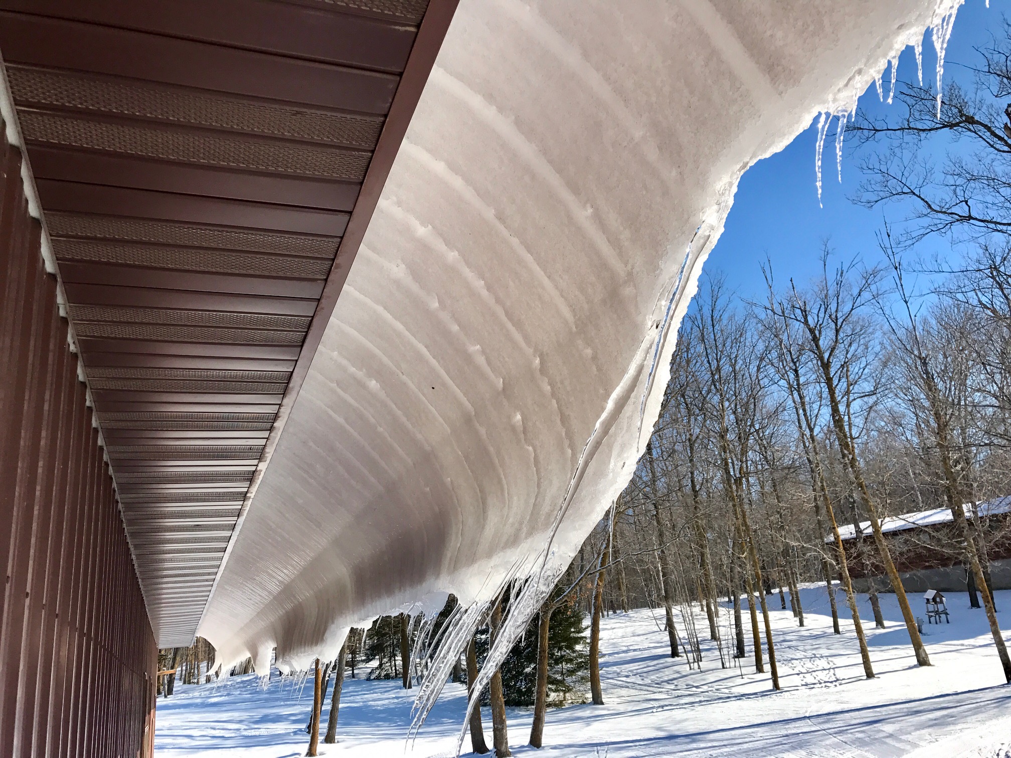 Snow slowly sliding off the roof!