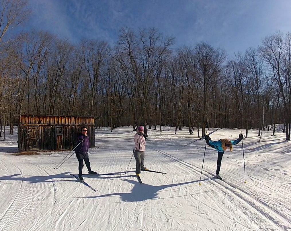 Previous Yoga retreat participants doing ski yoga